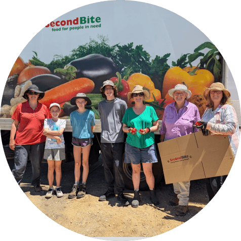 People standing in front of a van that says 'second bite'