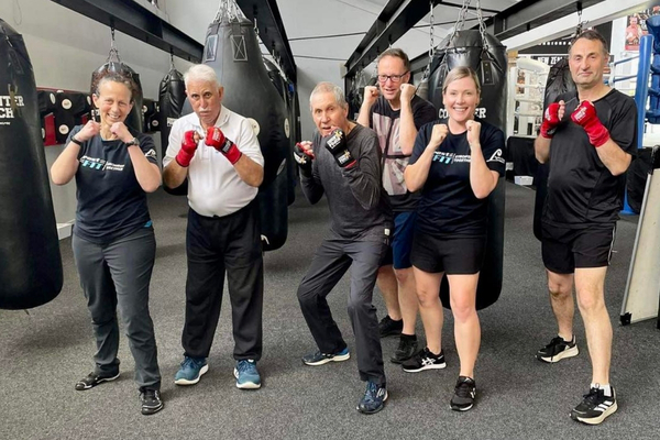group of prost-fit class members smiling and posing for a photo